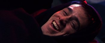 Movie still from “The Cable Guy” (1996), directed by Ben Stiller – A person with a smile on his face; Close Up shot, Overhead angle