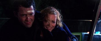 Movie still from “The Cable Guy” (1996), directed by Ben Stiller – A man and a woman smiling for the camera; Close Up shot, Low angle