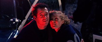 Movie still from “The Cable Guy” (1996), directed by Ben Stiller – A man and a woman sitting next to each other; Close Up shot, Low angle