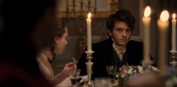 Movie still from “Bridgerton” (2020), created by Chris Van Dusen – A man and a woman sitting at a dinner table; Medium shot, Over the shoulder angle