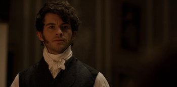 Movie still from “Bridgerton” (2020), created by Chris Van Dusen – A man in a black vest and a white neck tie; Close Up shot, Over the shoulder angle