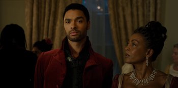 Movie still from “Bridgerton” (2020), created by Chris Van Dusen – A man and a woman standing next to each other in a room; Close Up shot, Over the shoulder angle