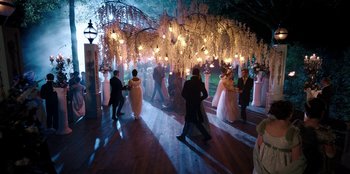 Movie still from “Bridgerton” (2020), created by Chris Van Dusen – A group of people dancing under a tree with lights; Extreme Wide shot, High angle