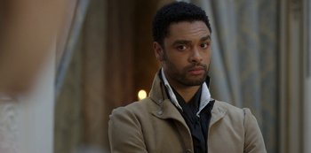 Movie still from “Bridgerton” (2020), created by Chris Van Dusen – A man in a brown jacket looking to his left; Close Up shot, Over the shoulder angle