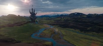 Movie still from “The Dark Crystal: Age of Resistance” (2019), created by Jim Henson – An aerial view of a river with a castle in the middle of it; Extreme Wide shot, High angle