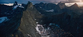Movie still from “The Dark Crystal: Age of Resistance” (2019), created by Jim Henson – A view of a mountain range with snow on it's side; Extreme Wide shot, High angle