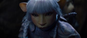 Movie still from “The Dark Crystal: Age of Resistance” (2019), created by Jim Henson – A person's face with a blue wig; Close Up shot, High angle