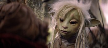 Movie still from “The Dark Crystal: Age of Resistance” (2019), created by Jim Henson – A doll with long white hair; Close Up shot, Over the shoulder angle
