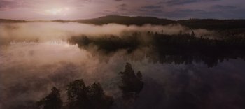Movie still from “The Dark Crystal: Age of Resistance” (2019), created by Jim Henson – A body of water surrounded by trees and clouds; Extreme Wide shot, High angle