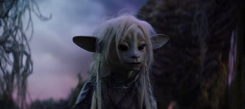 Movie still from “The Dark Crystal: Age of Resistance” (2019), created by Jim Henson – A person with a sheep mask and long white hair; Close Up shot, High angle