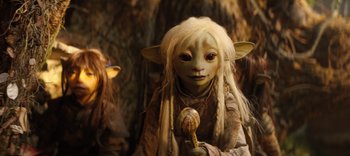 Movie still from “The Dark Crystal: Age of Resistance” (2019), created by Jim Henson – A woman with a long white hair holding a wooden stick; Close Up shot, High angle