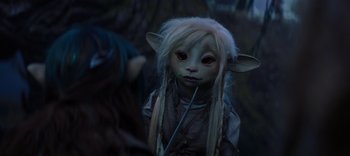 Movie still from “The Dark Crystal: Age of Resistance” (2019), created by Jim Henson – A doll with long white hair; Close Up shot, Over the shoulder angle
