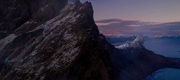 Movie still from “The Dark Crystal: Age of Resistance” (2019), created by Jim Henson – A view of a mountain range from a helicopter; Extreme Wide shot, High angle