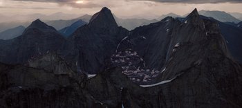 Movie still from “The Dark Crystal: Age of Resistance” (2019), created by Jim Henson – A view of a small town in the middle of the mountains; Extreme Wide shot, High angle