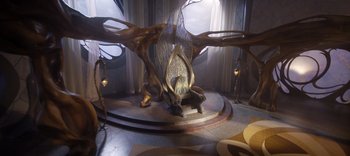 Movie still from “The Dark Crystal: Age of Resistance” (2019), created by Jim Henson – A chair in the middle of a room with a large tree; Wide shot, High angle