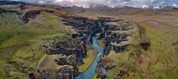 Movie still from “The Dark Crystal: Age of Resistance” (2019), created by Jim Henson – An aerial view of a river running through a valley; Extreme Wide shot, High angle