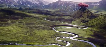 Movie still from “The Dark Crystal: Age of Resistance” (2019), created by Jim Henson – A view of a river flowing through a lush green valley; Extreme Wide shot, High angle