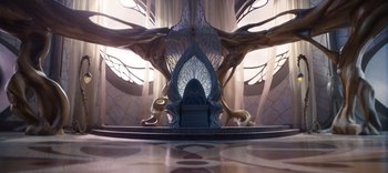 Movie still from “The Dark Crystal: Age of Resistance” (2019), created by Jim Henson – A chair in the middle of a room with trees in the background; Wide shot, High angle