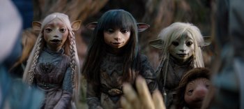 Movie still from “The Dark Crystal: Age of Resistance” (2019), created by Jim Henson – A woman with long black hair wearing a brown and black outfit; Medium shot, High angle