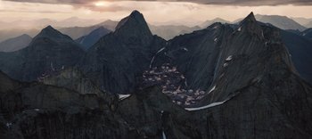 Movie still from “The Dark Crystal: Age of Resistance” (2019), created by Jim Henson – A view of a small town in the middle of the mountains; Extreme Wide shot, High angle