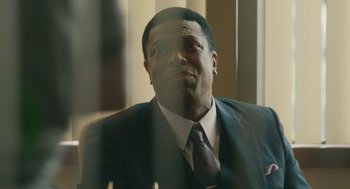 Movie still from “Air” (2023), directed by Ben Affleck – A man wearing a suit and tie looking up; Close Up shot, Over the shoulder angle