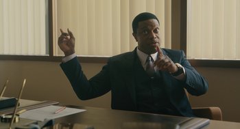 Movie still from “Air” (2023), directed by Ben Affleck – A man sitting at a table in front of a window; Medium shot, Over the shoulder angle