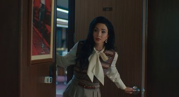 Movie still from “Air” (2023), directed by Ben Affleck – A young woman holding a wii controller in her hand; Medium shot, Over the shoulder angle