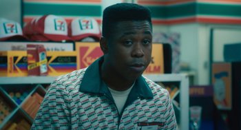 Movie still from “Air” (2023), directed by Ben Affleck – A man in a colorful shirt is looking at the camera; Close Up shot, Over the shoulder angle