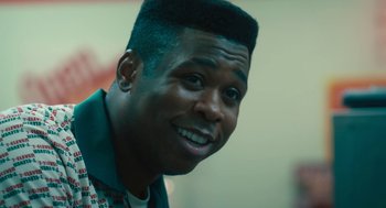 Movie still from “Air” (2023), directed by Ben Affleck – A person smiling; Close Up shot, Low angle