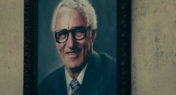 Movie still from “Air” (2023), directed by Ben Affleck – An older man wearing a suit and tie; Extreme Close Up shot, Low angle