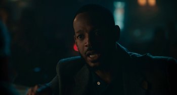 Movie still from “Air” (2023), directed by Ben Affleck – A man with a beard is looking at the camera; Close Up shot, Over the shoulder angle