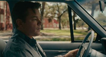 Movie still from “Air” (2023), directed by Ben Affleck – A man sitting in the driver's seat of a car; Close Up shot, Over the shoulder angle