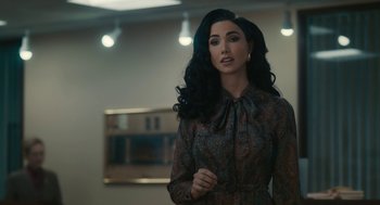 Movie still from “Air” (2023), directed by Ben Affleck – A woman with long black curly hair wearing a dress; Medium shot, Over the shoulder angle