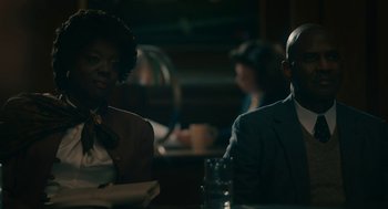 Movie still from “Air” (2023), directed by Ben Affleck – A man and a woman are sitting at a table; Medium shot, Over the shoulder angle