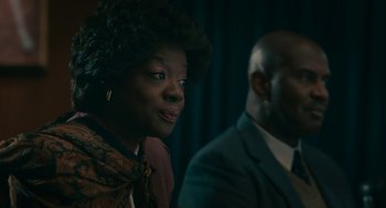 Movie still from “Air” (2023), directed by Ben Affleck – A woman sitting next to a man wearing a suit; Close Up shot, Over the shoulder angle