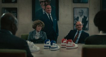 Movie still from “Air” (2023), directed by Ben Affleck – A group of people sitting around a conference table; Wide shot, Low angle