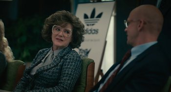 Movie still from “Air” (2023), directed by Ben Affleck – A woman sitting next to a man wearing glasses; Close Up shot, Over the shoulder angle