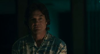 Movie still from “Air” (2023), directed by Ben Affleck – A man in a hawaiian shirt in a dark room; Close Up shot, Over the shoulder angle