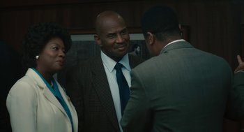 Movie still from “Air” (2023), directed by Ben Affleck – Two men and a woman in suits talking to each other; Medium shot, Over the shoulder angle