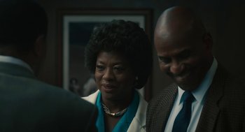 Movie still from “Air” (2023), directed by Ben Affleck – A woman and a man standing next to each other in a room; Close Up shot, Over the shoulder angle