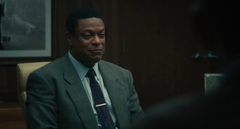 Movie still from “Air” (2023), directed by Ben Affleck – A man in a suit and a tie; Close Up shot, Over the shoulder angle