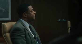 Movie still from “Air” (2023), directed by Ben Affleck – A man sitting in a chair in a room; Close Up shot, Over the shoulder angle