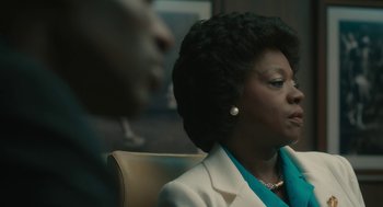 Movie still from “Air” (2023), directed by Ben Affleck – A woman sitting in front of a man in a chair; Close Up shot, Over the shoulder angle