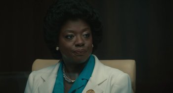 Movie still from “Air” (2023), directed by Ben Affleck – A woman in a white jacket sitting in a chair; Close Up shot, Over the shoulder angle