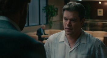 Movie still from “Air” (2023), directed by Ben Affleck – A man is talking to another man in an office; Medium shot, Over the shoulder angle