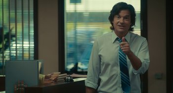 Movie still from “Air” (2023), directed by Ben Affleck – A man wearing a blue and white striped neck tie; Medium shot, Low angle