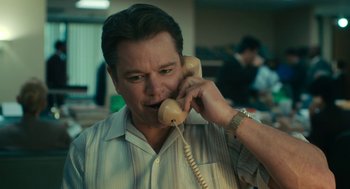 Movie still from “Air” (2023), directed by Ben Affleck – A man talking on a phone while wearing a striped shirt; Close Up shot, Low angle