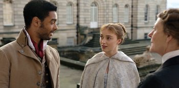 Movie still from “Bridgerton” (2020), created by Chris Van Dusen – A man and a woman standing next to each other; Medium shot, Over the shoulder angle