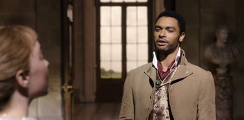 Movie still from “Bridgerton” (2020), created by Chris Van Dusen – A man standing in front of an open door; Medium shot, Over the shoulder angle