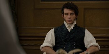 Movie still from “Bridgerton” (2020), created by Chris Van Dusen – A man wearing a vest and a white shirt is sitting in a chair; Close Up shot, Over the shoulder angle